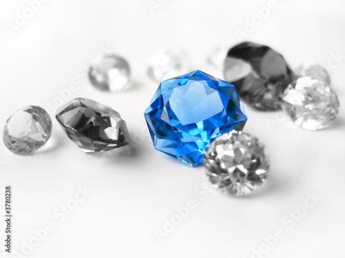 Blue gemstone among colorless gemstones