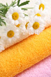 stack of towels and nice marigolds - body care