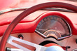 Speedometer and wheel of classic red car cloose-up Speedometer and wheel of classic red car cloose-up