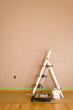 Freshly painted interior wall with ladder and tools