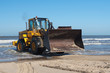 Action shot of an yellow digger at the coast