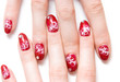 Woman fingers with decorated nails. Isolated on white.