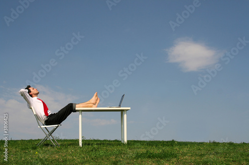 Businessman using laptop outdoors