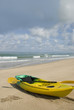 Ocean Kayak on the beach with cloudy sky