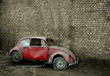 Grunge car in front of a brick wall with copy space