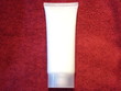 Beauty lotion /  cream on deep red towel   