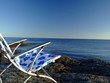 folding chair in front of the ocean