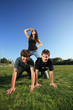 Photo: Young woman riding on the backs of her friends Young woman riding on the backs of her friends
