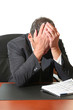 Frustrated business man hold his head in his hands.