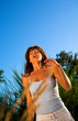 woman sneezing outdoor on a field over blue sky