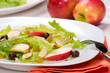 Fall salad with apples, almonds, raisins  and black olives