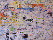 Wall of torn ads in the city