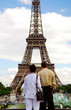 Tourist couple enjoying the view of Eiffel tower in Paris.