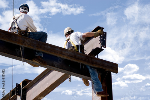 Photo: Two ironworkers atop the skeleton of a modern building Two ironworkers atop the skeleton of a modern building