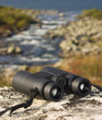 binocular on a hilltop overlooking a lake