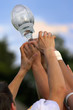 Hands reaching for a trophy after winning the championship game. Hands reaching for a trophy after winning the championship game.