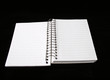 open notebook isolated on black
