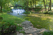 wooden bring over small waterfall