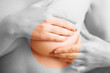 Photo: Woman examining her breast for signs of breast cancer Woman examining her breast for signs of breast cancer