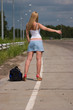 Itenerant attractive woman on road.