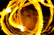 A man dancing whit a burning stick.