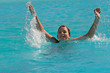 The girl plays in a swimming pool
