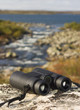 binocular on a hilltop overlooking a lake