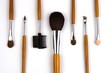 Cosmetic brushes lined up in white background.