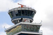 Airport control tower over cloudy blue sky