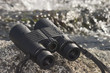 wet binoculars in the field next to a stream
