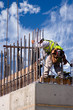 High Wall Worker Against Clouds
