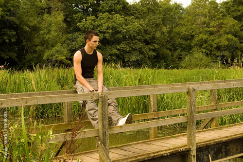 Photo: Man sitting on a Bridge Man sitting on a Bridge
