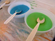 green and blue sand and spoons at the fair