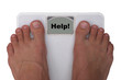 Male feet on a scale. Showing "help"