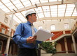 man in hardhat checking construction site