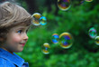 beautiful four years old playing with bubbles