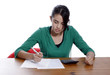  A young woman holding a pen, doing her taxes