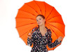 Young girl with holding a orange umbrella 