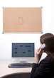 Beautiful girl using telephone, estate agent. Corkboard.