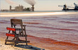 Polluted Water Near Industrial Site with No Swimming Sign