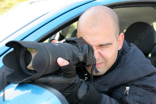 Photo: Professional photographer in action with telephoto lens Professional photographer in action with telephoto lens