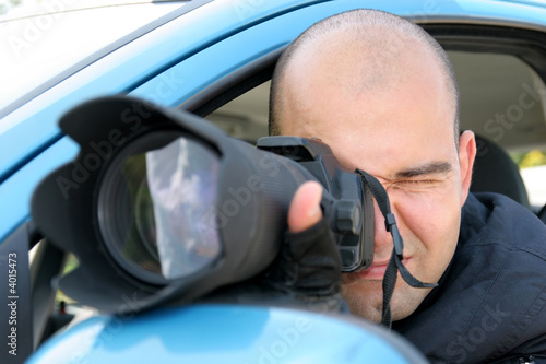 Photo: Professional photographer in action with telephoto lens Professional photographer in action with telephoto lens