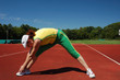 Active senior woman stretching in a stadium
