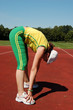 Active senior woman stretching in a stadium