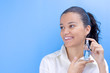 young pretty girl holding perfume