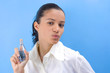 young pretty girl holding perfume