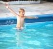 Boy Jumping Into Swimming Pool