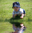 Baby in the Grass by Water Baby in the Grass by Water