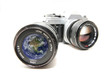 Vintage photo camera with the globe reflected in the lens