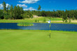 Putting green beside a pond
